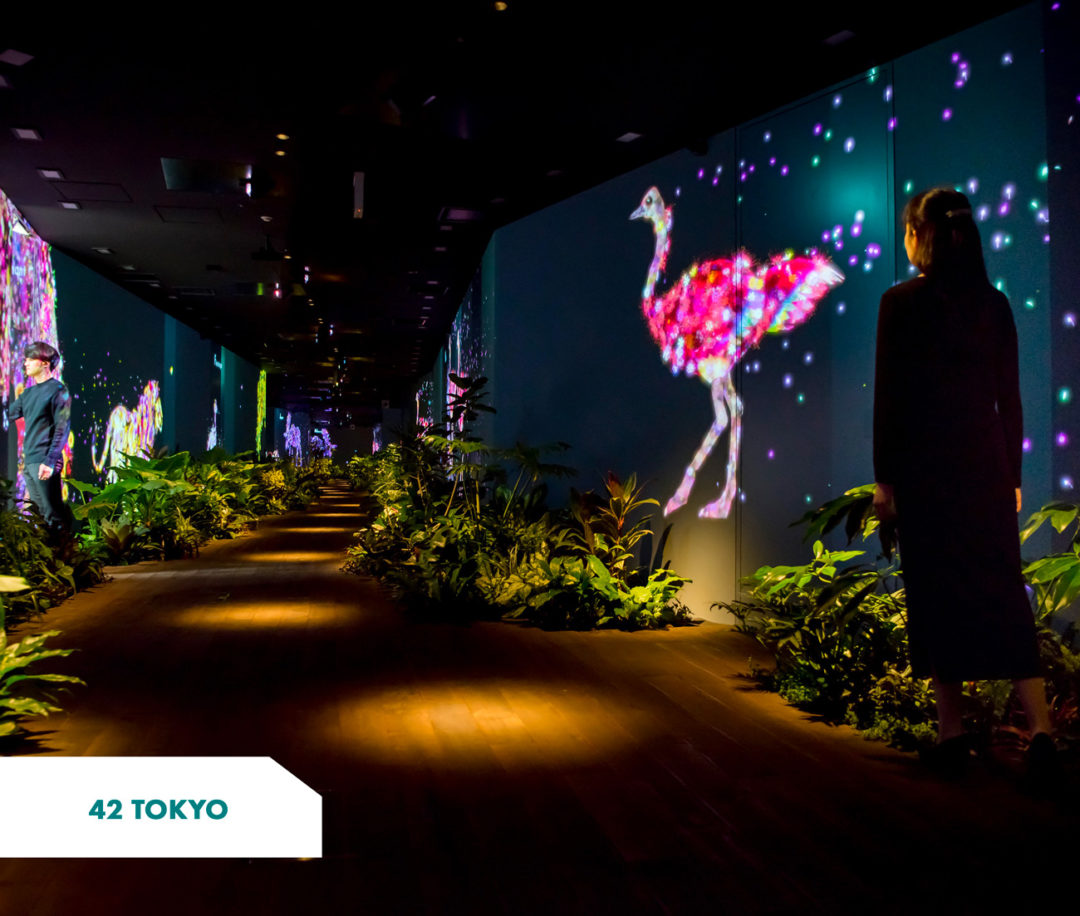 42 Tokyo's corridor with plants on the sides and giant screens with animated animals on them (Japan)