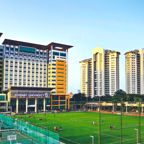 Exterior view of the buildings of 42 Kuala Lumpur and the partner university with a soccer field and basket field in front (Malaysia)