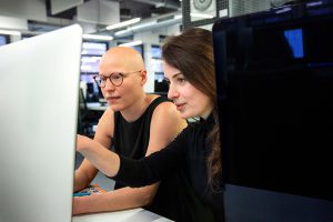 Two students coding in the workspace