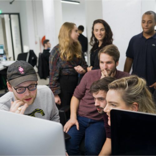 Small group of students working and talking together - Codam campus (The Netherlands)