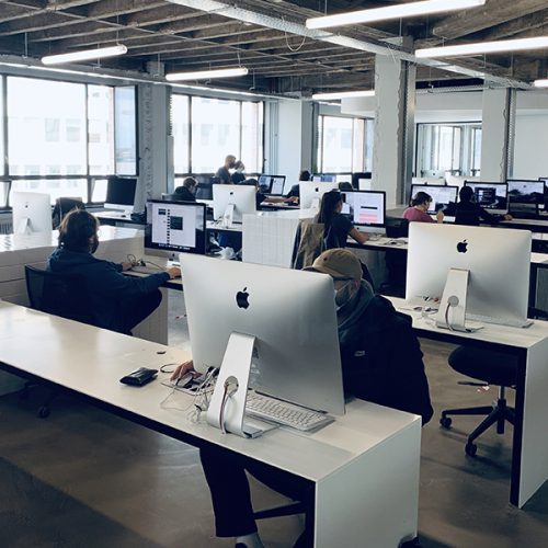 Workroom with iMacs equipment and students - campus of 19 in Brussels (Belgium)