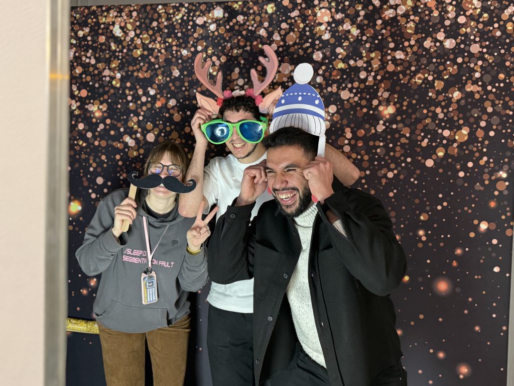 Photo of 3 students wearing funny hats