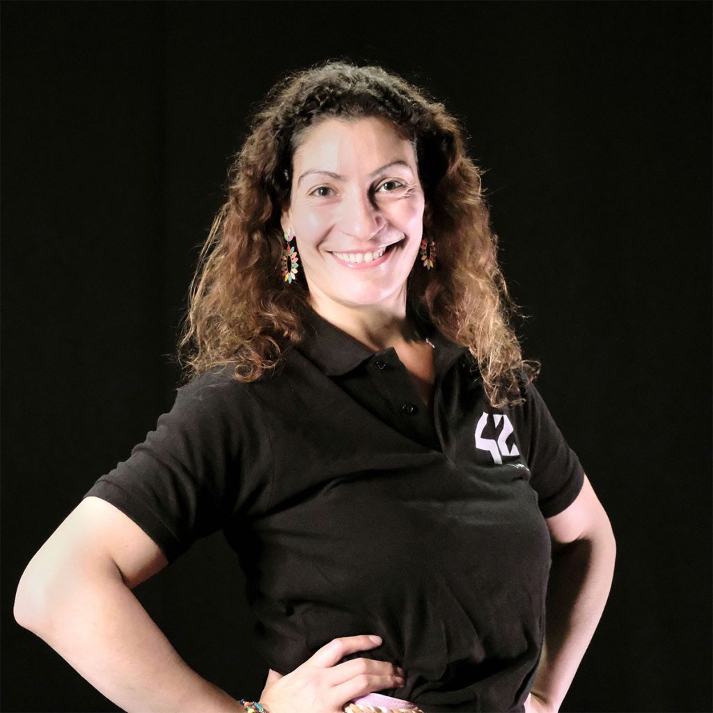 Taninna Portebos, director of IOTA posing in front of a black background